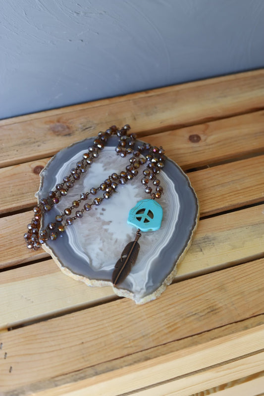 102367 R2-17 BRONZE CRYSTAL NECKLACE W/ PEACE AND FEATHER